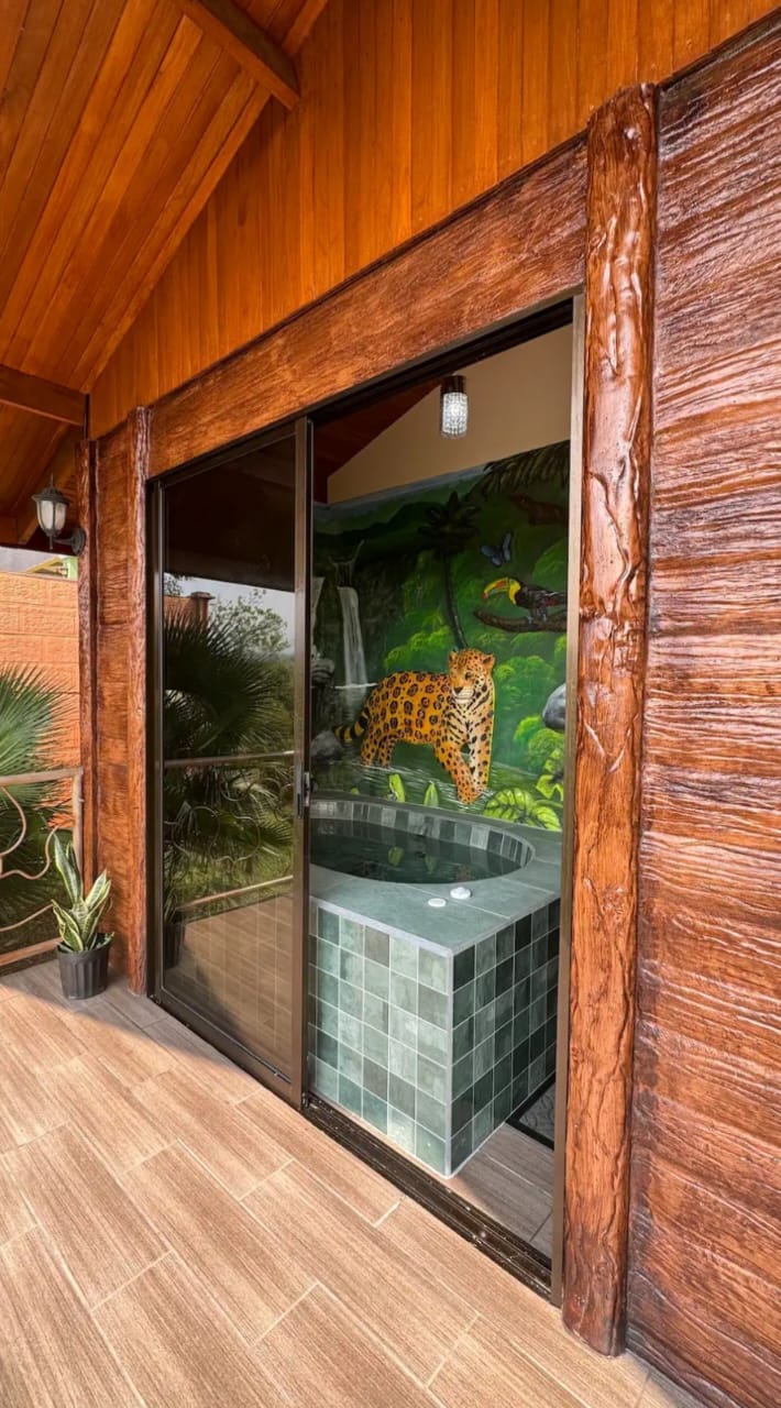 Jacuzzi seen through sliding glass doors from the wooden porch