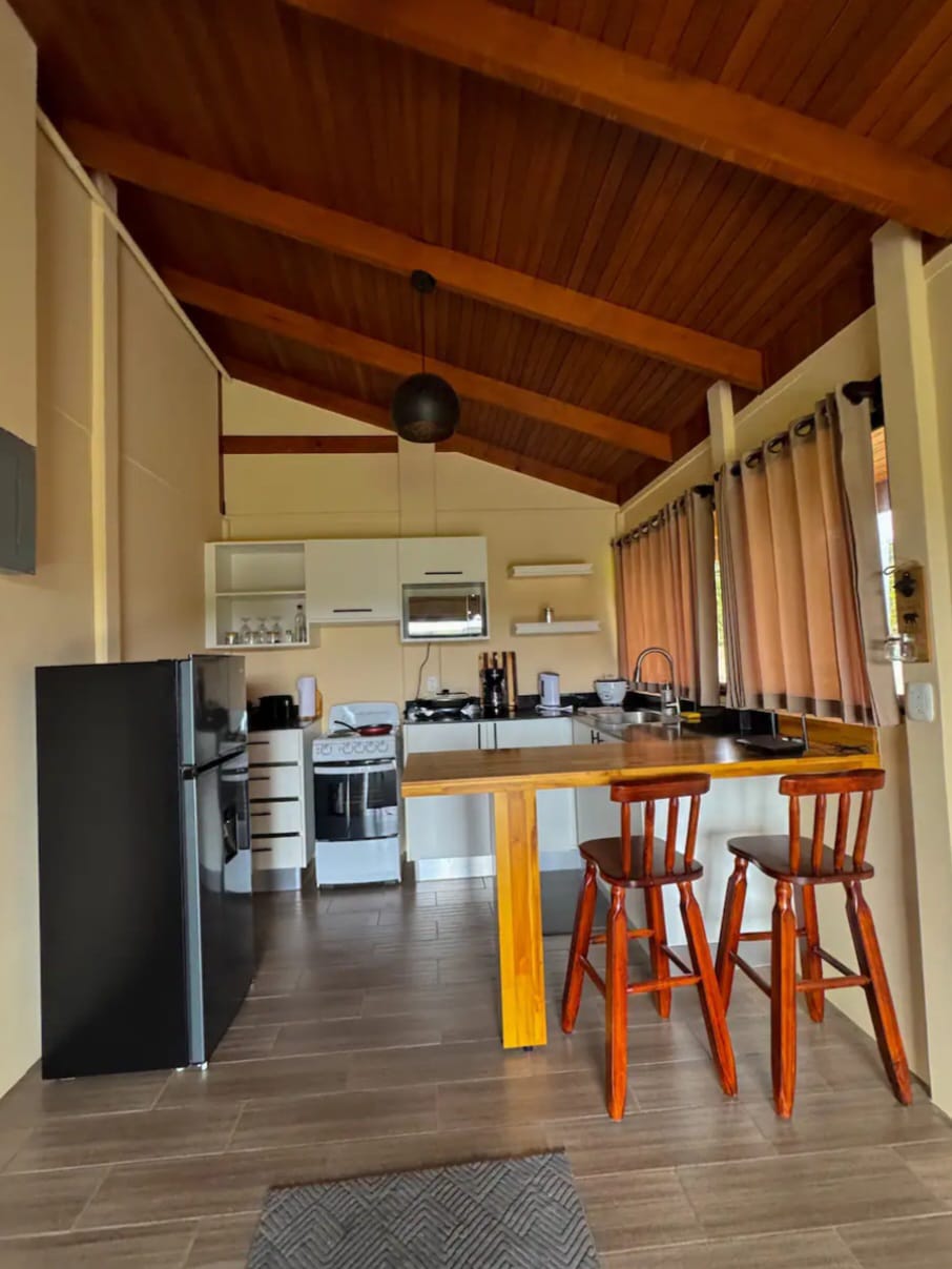 Full kitchen with breakfast bar, stove, oven, microwave and refrigerator