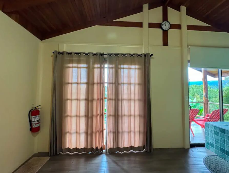 Bright living area opening onto the porch through sliding glass doors