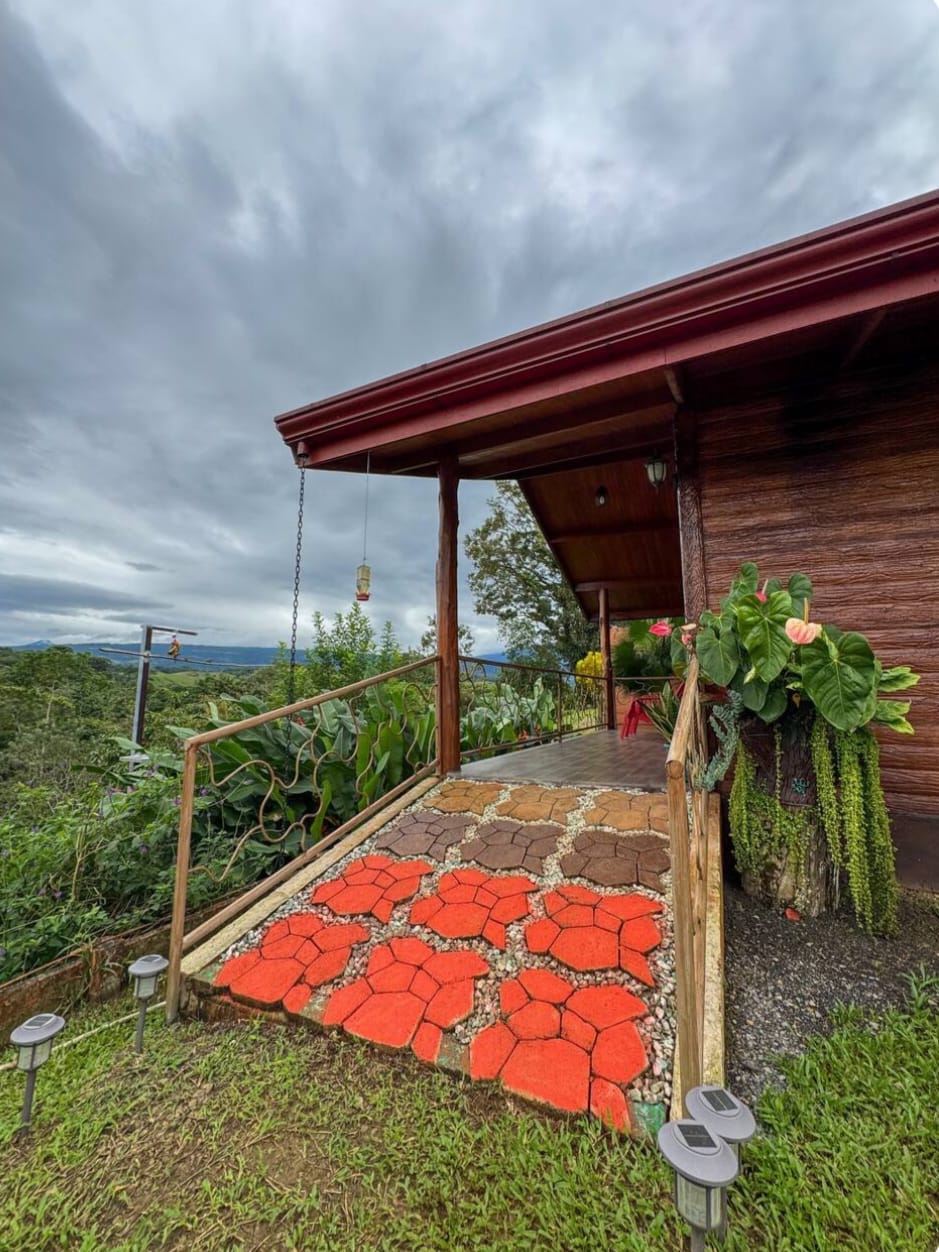 Cabin porch with hummingbird feeder and mountain views